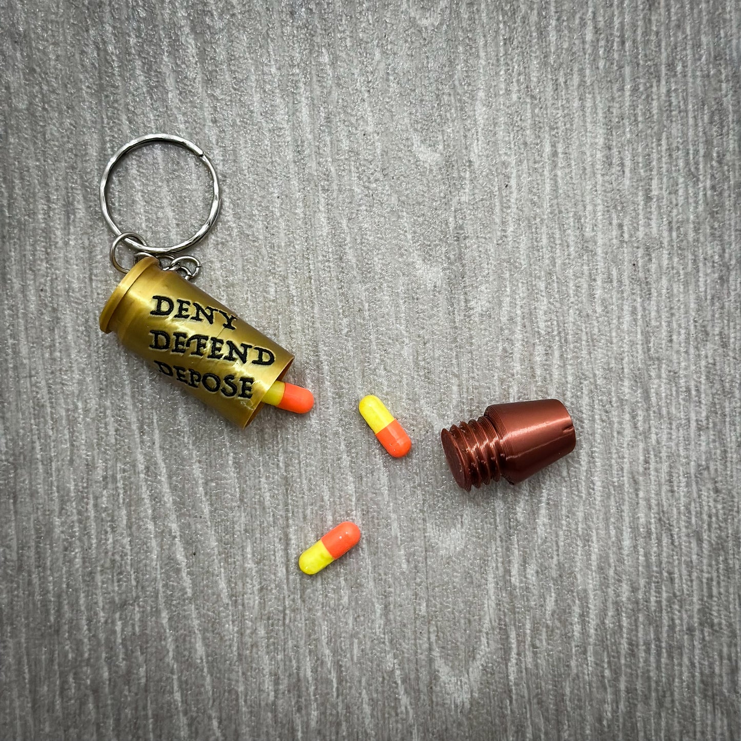 Deny Defend Depose Pill holder keychain