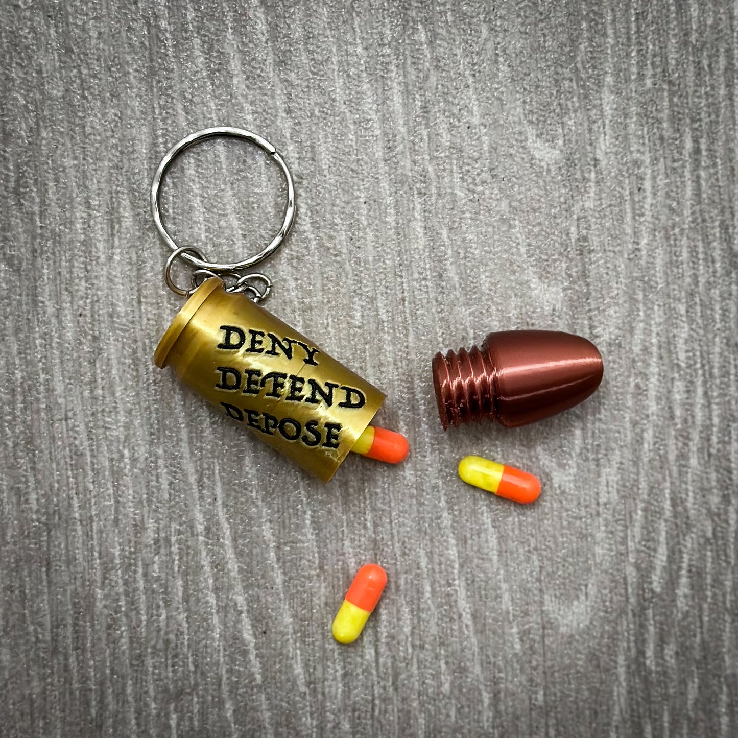 Deny Defend Depose Pill holder keychain