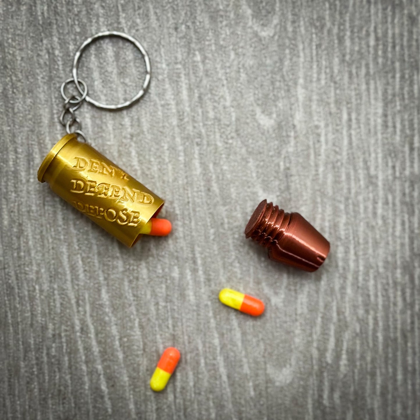 Deny Defend Depose Pill holder keychain